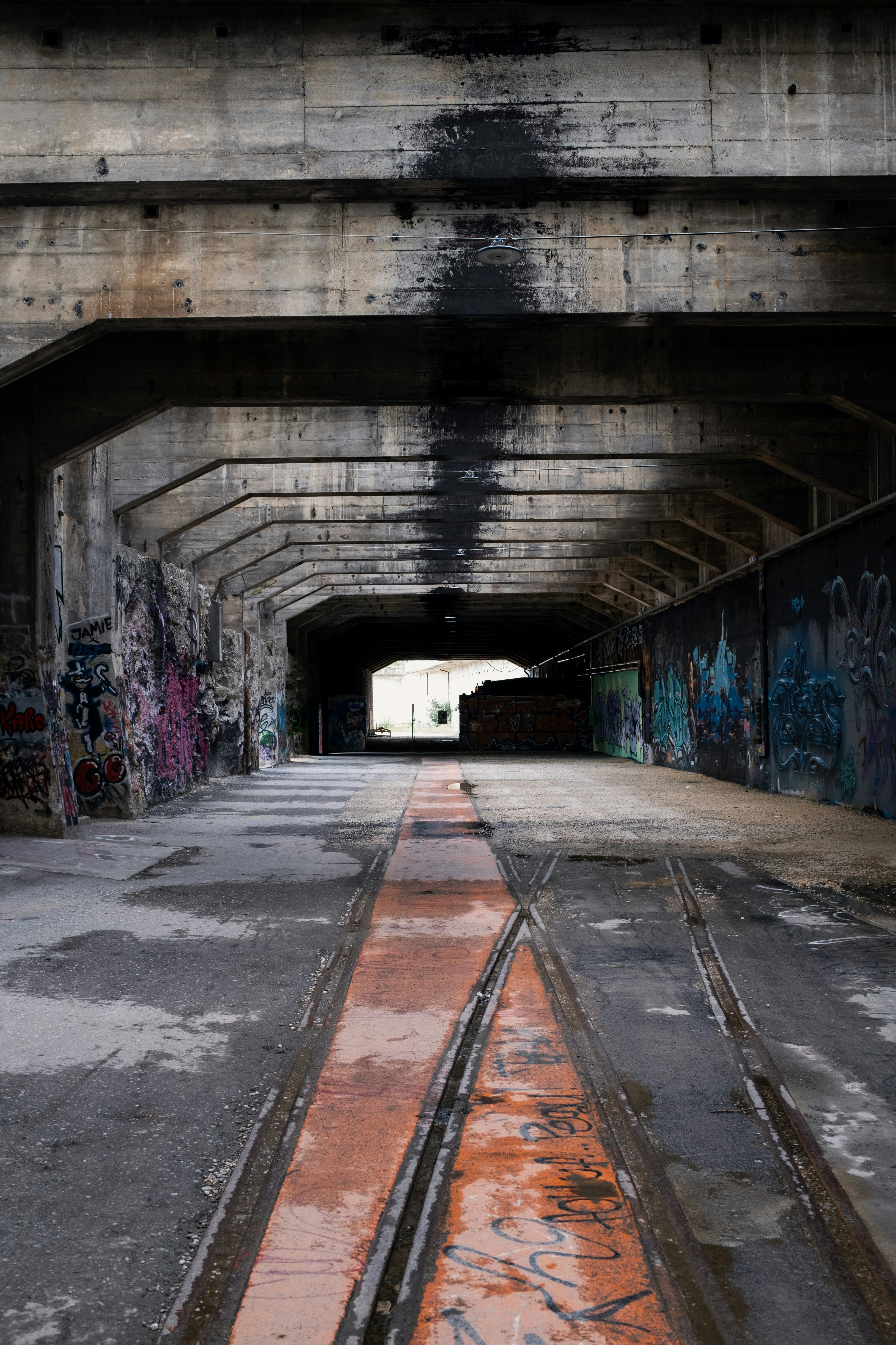 gray concrete tunnel with graffiti